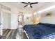 Open concept main bedroom features an ensuite bathroom, transom windows, and a view into the ensuite bathroom at 1647 Stable Trl, Palm Harbor, FL 34685