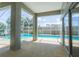 Covered patio features a screened-in in-ground pool and sliding glass doors to the house at 1647 Stable Trl, Palm Harbor, FL 34685