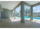 Covered patio features a screened-in in-ground pool and sliding glass doors to the house at 1647 Stable Trl, Palm Harbor, FL 34685