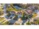 A stunning aerial view of a home on a lot near a tranquil pond and lush greenery at 7327 Brightwaters Ct, New Port Richey, FL 34652