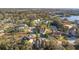 A beautiful aerial view of a two-story home on a scenic lot with mature trees at 7327 Brightwaters Ct, New Port Richey, FL 34652