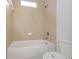 Clean, bright bathroom featuring tiled walls, a toilet and a tub with shower at 7327 Brightwaters Ct, New Port Richey, FL 34652