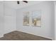 Bedroom with carpet, closet, ceiling fan, and a window providing natural light at 7327 Brightwaters Ct, New Port Richey, FL 34652