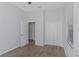 Carpeted bedroom features a large closet with an open door and a window for natural light at 7327 Brightwaters Ct, New Port Richey, FL 34652