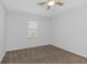 Bright bedroom features a ceiling fan and a window that allows natural light to filter in at 7327 Brightwaters Ct, New Port Richey, FL 34652