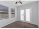 Carpeted bedroom has French doors for deck access and large windows at 7327 Brightwaters Ct, New Port Richey, FL 34652