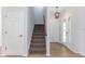 The entryway showcases the staircase, front door with decorative glass, and tile flooring at 7327 Brightwaters Ct, New Port Richey, FL 34652