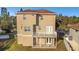 Rear exterior view of a two-story home with a balcony at 7327 Brightwaters Ct, New Port Richey, FL 34652