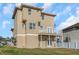Back elevation of the home featuring a second story balcony at 7327 Brightwaters Ct, New Port Richey, FL 34652