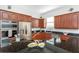 Well-equipped kitchen featuring dark wood cabinets, modern appliances, and granite countertops at 7327 Brightwaters Ct, New Port Richey, FL 34652