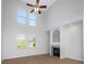 Bright, open living room with fireplace and high ceiling with large windows at 7327 Brightwaters Ct, New Port Richey, FL 34652