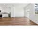 Open-concept living area with vinyl floors, a modern kitchen, and a sliding glass door at 11905 Sylvia St, Dade City, FL 33525
