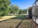 The backyard is spacious with mature trees and landscaping, offering a private and serene outdoor setting at 12402 Creek Edge Dr, Riverview, FL 33579