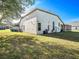 Expansive backyard showcasing the home's architecture, including a screened patio and well-maintained lawn at 12402 Creek Edge Dr, Riverview, FL 33579