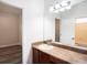 Bathroom features a vanity with sink, a large mirror, and an adjoining room at 12402 Creek Edge Dr, Riverview, FL 33579