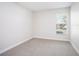 Bright bedroom with neutral carpeting and a window offering outdoor views at 12402 Creek Edge Dr, Riverview, FL 33579