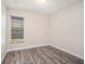 This cozy bedroom offers natural light from the window and durable wood-look flooring at 12402 Creek Edge Dr, Riverview, FL 33579
