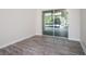Comfortable bedroom featuring wood floors and a sliding glass door that leads to a screened lanai at 12402 Creek Edge Dr, Riverview, FL 33579
