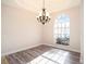 Elegant dining room featuring wood floors, a large window, a chandelier, and plenty of natural light at 12402 Creek Edge Dr, Riverview, FL 33579