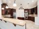 Modern kitchen with stainless steel appliances, granite countertops, and dark wood cabinetry at 12402 Creek Edge Dr, Riverview, FL 33579