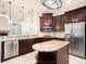 Gourmet kitchen with stainless steel appliances, a center island, and elegant cabinetry at 12402 Creek Edge Dr, Riverview, FL 33579