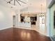 Spacious living area with hardwood flooring, seamlessly connecting to the modern kitchen with granite countertops at 12402 Creek Edge Dr, Riverview, FL 33579