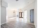 Bright and airy living room featuring tile and wood flooring, natural lighting, and arched doorways at 12402 Creek Edge Dr, Riverview, FL 33579