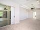 Spacious main bedroom with a ceiling fan, tray ceilings, and sliding glass doors leading to the outdoors at 12402 Creek Edge Dr, Riverview, FL 33579