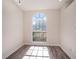 Home office with a large arched window and wood-look flooring, providing a bright and functional workspace at 12402 Creek Edge Dr, Riverview, FL 33579