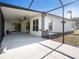 View of the screened-in patio with fans and access to the backyard, providing an indoor-outdoor living experience at 12402 Creek Edge Dr, Riverview, FL 33579