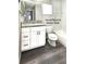 Updated bathroom boasts a granite countertop, white vanity, and modern fixtures at 1610 Spinning Wheel Dr, Lutz, FL 33559