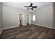 Spacious main bedroom features gray walls, wood flooring, a ceiling fan, and natural light at 1610 Spinning Wheel Dr, Lutz, FL 33559