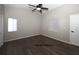 Main bedroom features gray walls, wood flooring, natural light, and a ceiling fan at 1610 Spinning Wheel Dr, Lutz, FL 33559