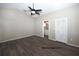 Spacious main bedroom features gray walls, wood flooring, and a ceiling fan at 1610 Spinning Wheel Dr, Lutz, FL 33559