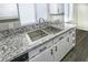Kitchen featuring stainless steel sink, faucet, and gray granite countertops at 1610 Spinning Wheel Dr, Lutz, FL 33559