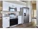 The kitchen features stainless steel appliances, granite countertops, and white cabinets at 1610 Spinning Wheel Dr, Lutz, FL 33559
