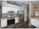 Kitchen area features stainless appliances, granite countertops, and white cabinetry at 1610 Spinning Wheel Dr, Lutz, FL 33559