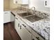 Kitchen sink features stainless steel appliances, granite countertops, and brushed nickel fixtures at 1610 Spinning Wheel Dr, Lutz, FL 33559