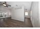 Living room featuring modern flooring, ceiling fan and view into kitchen area, bright and open layout at 1610 Spinning Wheel Dr, Lutz, FL 33559