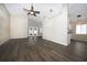 Spacious living room featuring vaulted ceilings, modern ceiling fan, and French doors to backyard at 1610 Spinning Wheel Dr, Lutz, FL 33559