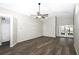 Bright living room with vaulted ceiling, ceiling fan, and stylish wood-look flooring throughout at 1610 Spinning Wheel Dr, Lutz, FL 33559
