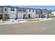New construction townhomes line a street with sidewalks, manicured lawns, and available homes signs at 11929 Sylvia St, Dade City, FL 33525
