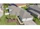 This aerial view shows a well-manicured lawn and a three car garage at 32554 Silvercreek Way, Wesley Chapel, FL 33545