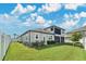 This is a fenced backyard with a well-maintained lawn and beautiful landscaping at 32554 Silvercreek Way, Wesley Chapel, FL 33545