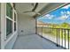 Covered balcony overlooking the backyard with a ceiling fan and railing, perfect for enjoying the outdoors at 32554 Silvercreek Way, Wesley Chapel, FL 33545