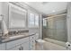 Bathroom featuring a large vanity, glass shower, and a window with natural light at 32554 Silvercreek Way, Wesley Chapel, FL 33545