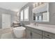 Modern bathroom with a freestanding tub, double vanities, and a separate glass-enclosed shower at 32554 Silvercreek Way, Wesley Chapel, FL 33545