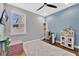 Inviting bedroom with a playful decor, featuring a dollhouse and bookshelf, creating a cheerful atmosphere at 32554 Silvercreek Way, Wesley Chapel, FL 33545