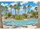 The zero entry community pool has tall palm trees surrounding it and lounge chairs for relaxing at 32554 Silvercreek Way, Wesley Chapel, FL 33545