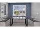 Dining area featuring a modern table with built-in benches and large windows with plantation shutters at 32554 Silvercreek Way, Wesley Chapel, FL 33545